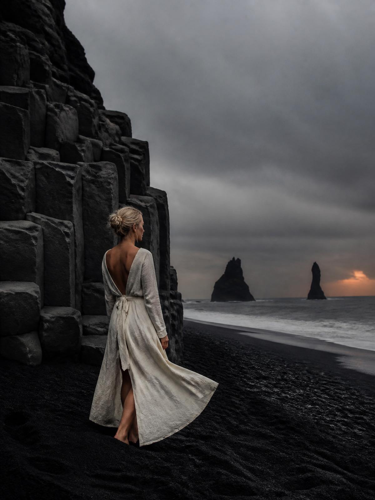 Woman on black sand beach in Iceland